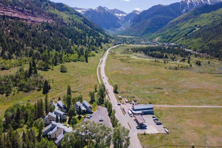 765 W Highway 145 A2 summer aerial view of condo complex with Telluride peaks beyond.