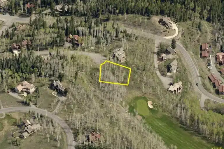 Summer aerial view of real estate listing Lot 628H Double Eagle Way, Mountain Village with golf fairway nearby.