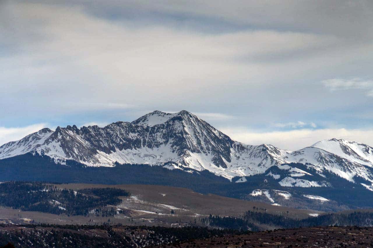 Snowy southern San Juan mountains viewed from Lot 3 46X Road, Norwood Colorado real estate listing.