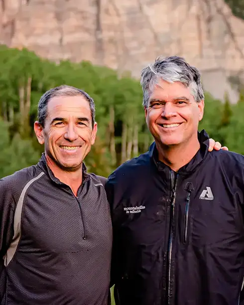 Asa Van Gelder and Mike Shimkoanis in summer with Telluride aspens and mountains in background.