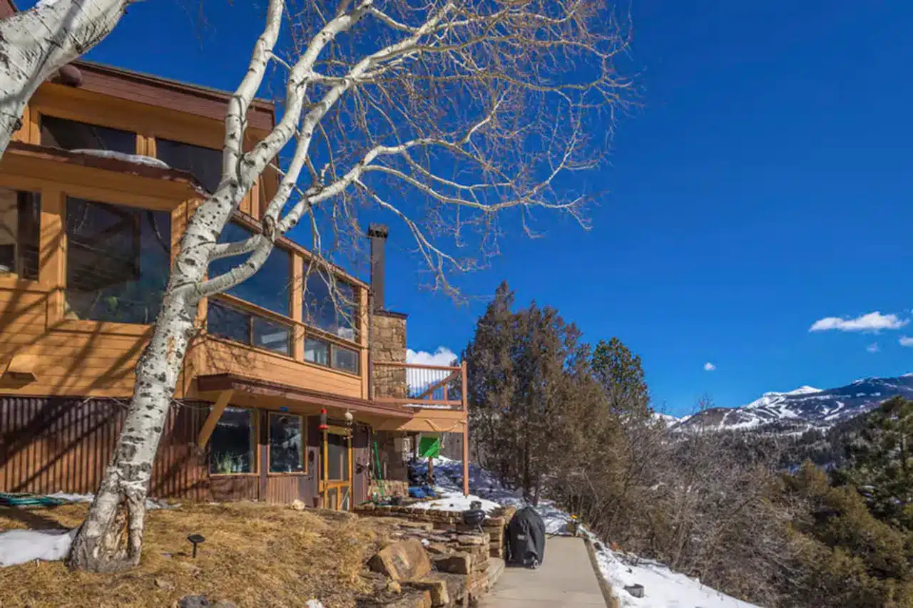 70 Nimbus Drive, Telluride, Colorado real estate listing exterior with blue skies and mountain views.