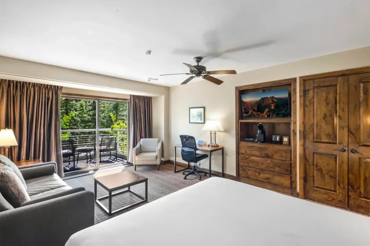 Bright interior of Shimkonis Partners real estate listing, Peaks condo 439, with verdant summer balcony view.
