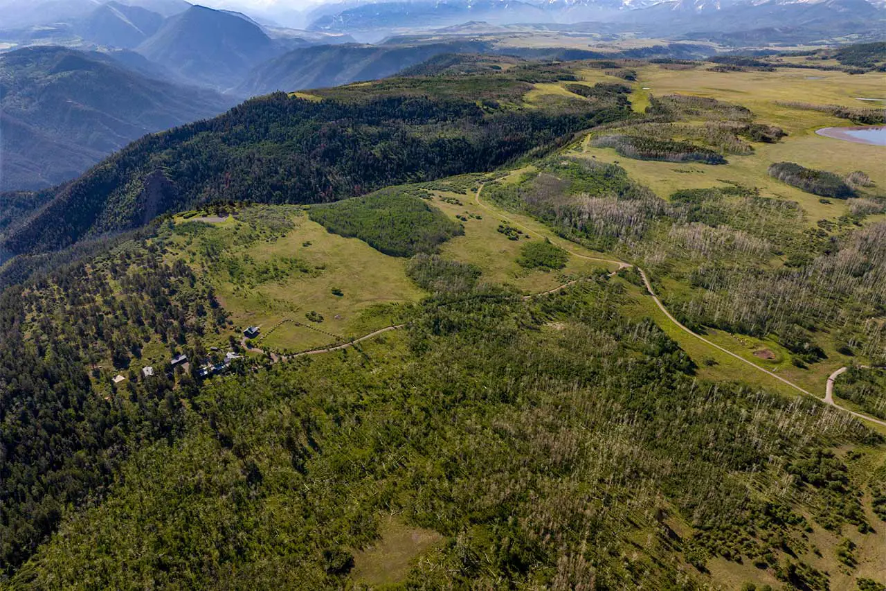 Shimkonis Partners Telluride area real estate listing, Laughing Dog Ranch: a rare 243-acre sanctuary, summer blue-sky aerial view with lakes and mountains
