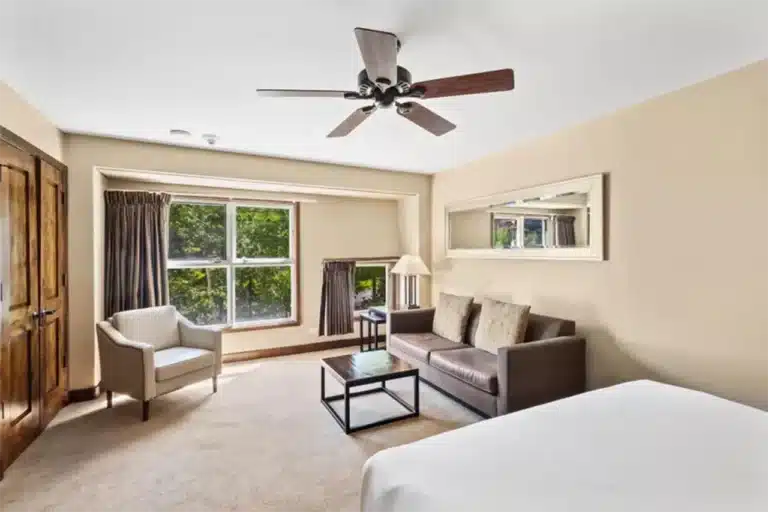 Bright interior of Shimkonis Partners real estate listing, Peaks condo 333, with verdant summer view.