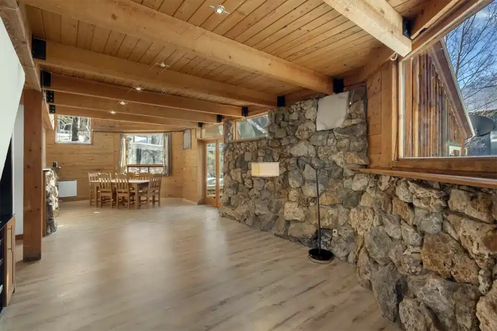 Shimkonis Partners Telluride area real estate listing, 34 Aurum Street, Ophir, spacious living area with stone fireplace.