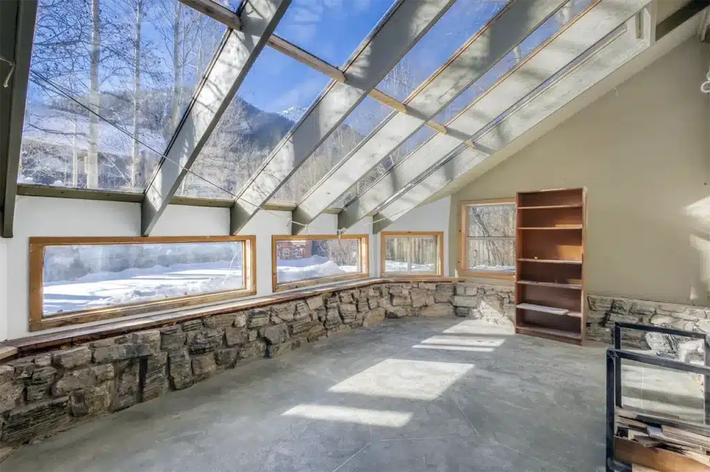 Shimkonis Partners Telluride area real estate listing, 34 Aurum Street, Ophir, sun room interior with sunny winter views .