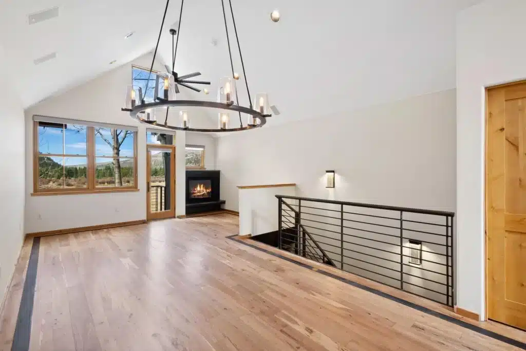 Shimkonis Partners real estate listing, 240 Mahoney Drive, Telluride, bright, remodeled living area with fireplace and summer view of valley floor