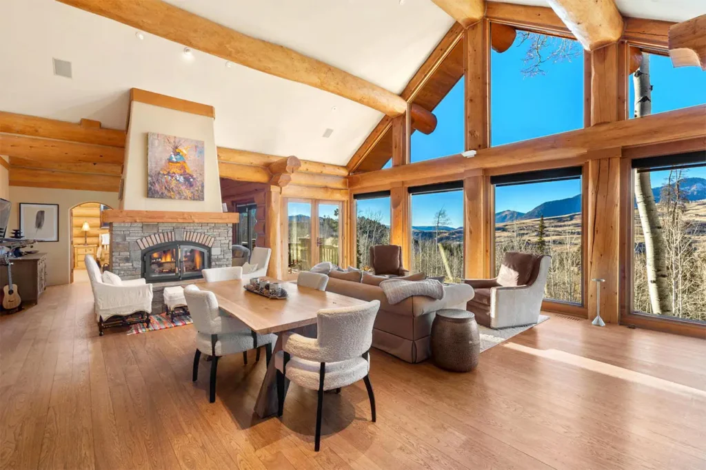 Bright interior living area of Shimkonis Partners Telluride area real estate listing, 103 Birdie Drive, Mountain Village, featuring large window mountain views