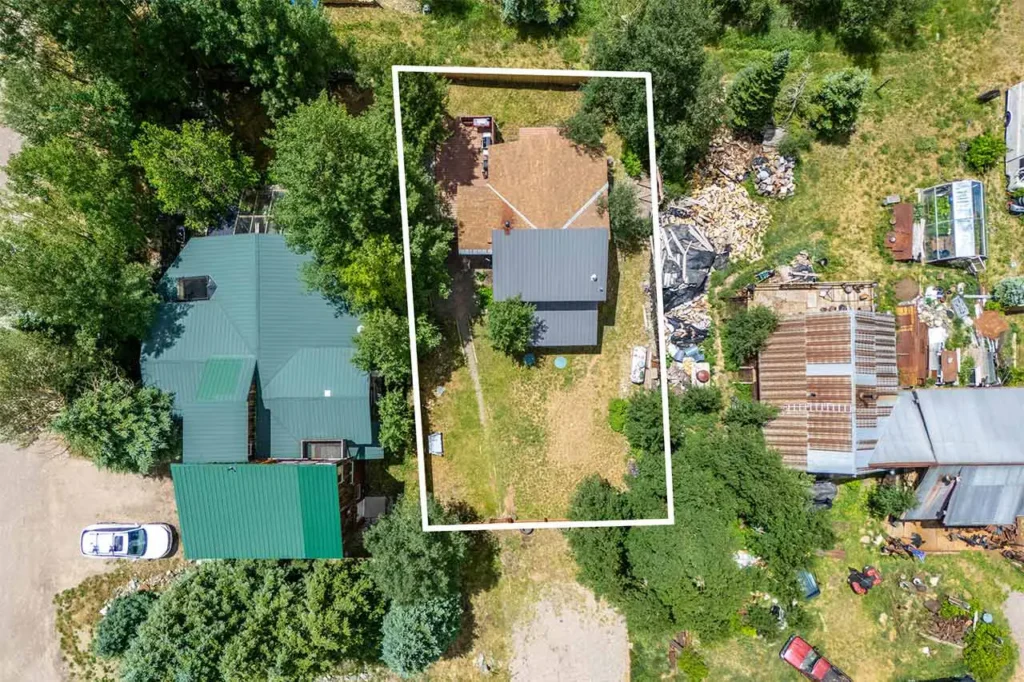 Aerial summer view of Shimkonis Partners Telluride area real estate listing, 30 Aurum Street, Ophir, with property outline