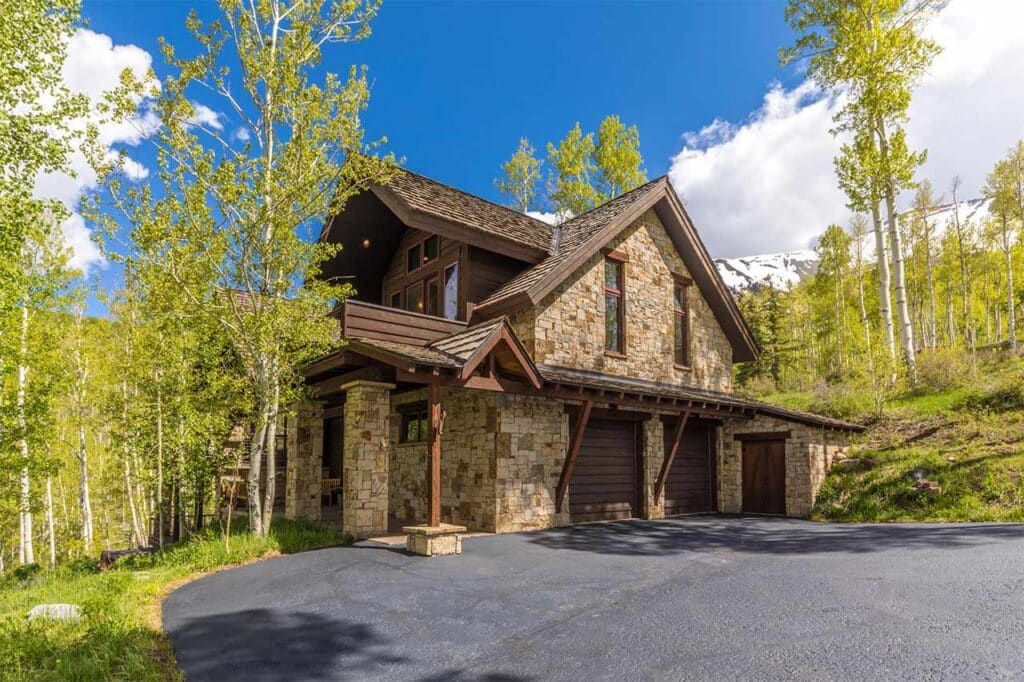Sunny summer exterior view of Shimkonis Partners Telluride real estate listing, 107 Joaquin Road, Telluride