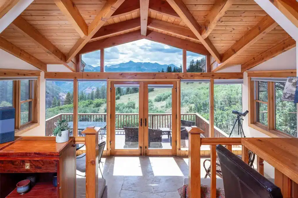 Bright living area of Shimkonis Partners Telluride area real estate listing, 1075 High Plains Drive, Placerville with expansive mountain views