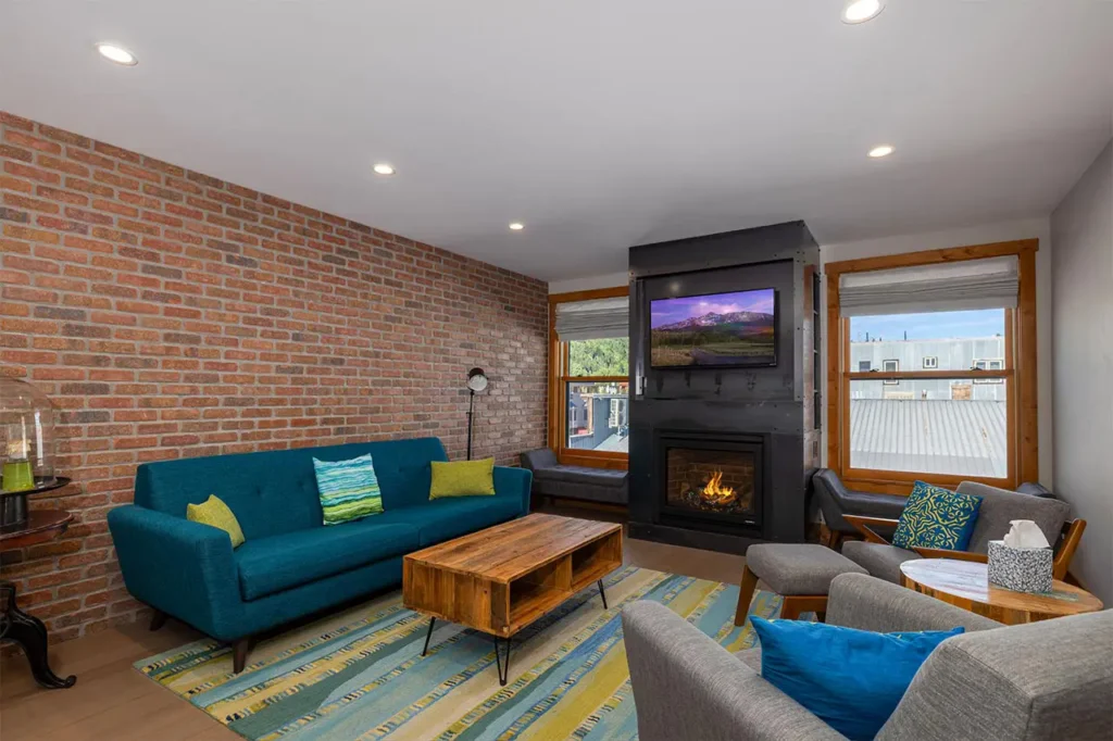 Bright living area of Shimkonis Partners Telluride real estate listing, Black Bear #302, with town and mountain views