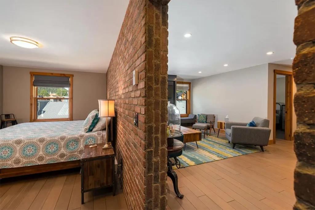 Bright living area of Shimkonis Partners Telluride real estate listing, Black Bear #302, with main bedroom
