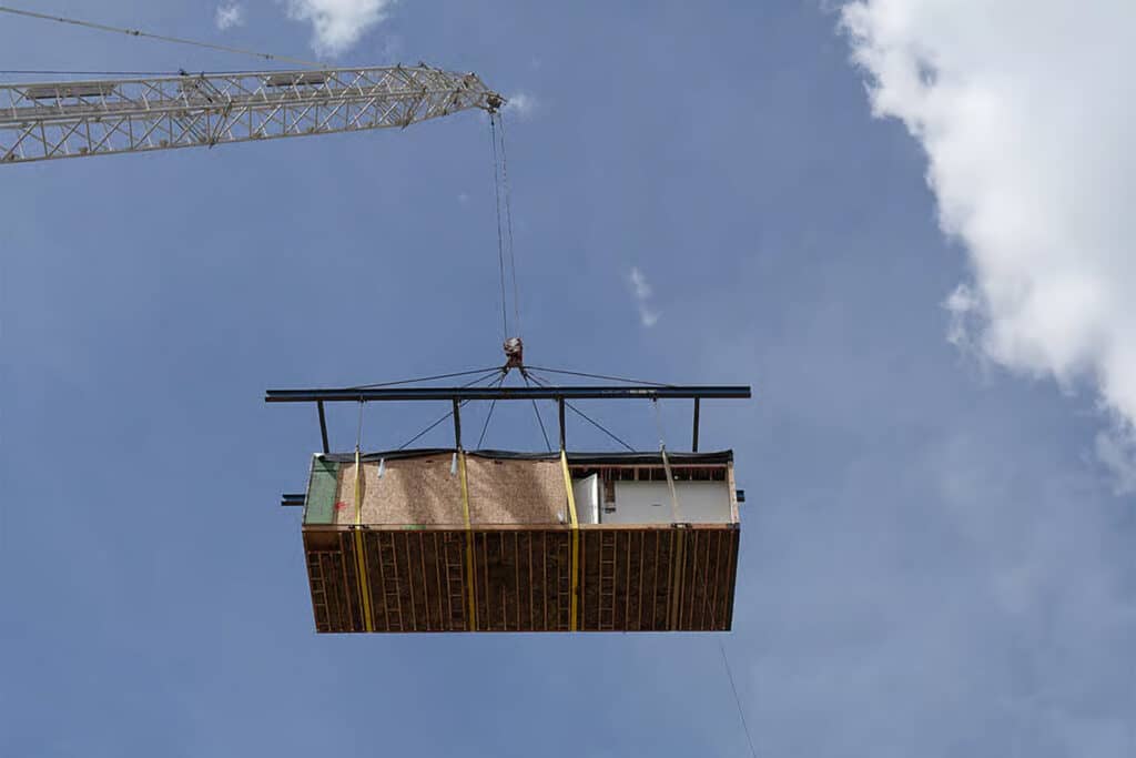 Crane lowering a prefabricated section of Tellurides Summit Residences